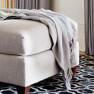 Throw on accent chair with etagere in the background