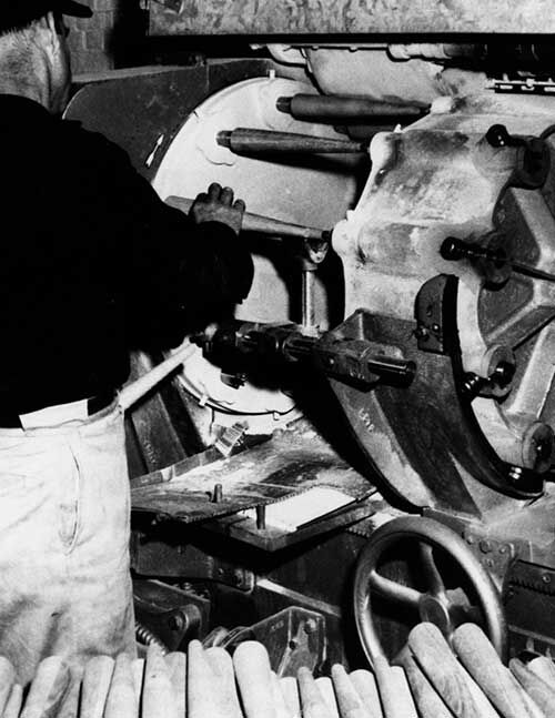 Craftsman using machine finishing chair legs